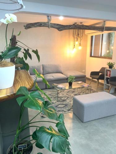 a living room with a couch and a table at Berlor Airport Inn in Alajuela City