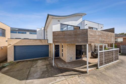a large brick house with a garage at Puebla Casa 1 35a in Torquay