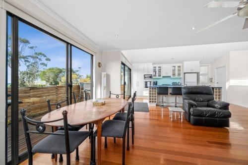 a dining room and living room with a table and chairs at Puebla Casa 1 35a in Torquay