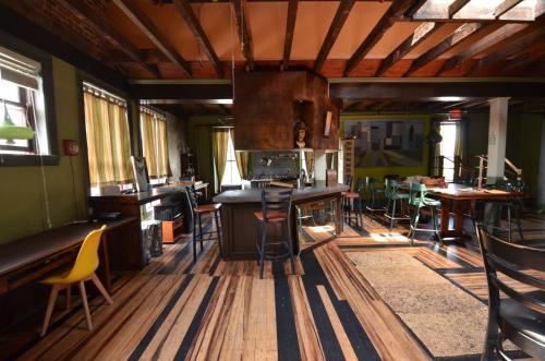 a room with wooden floors and tables and chairs at Michie Hostel in Providence
