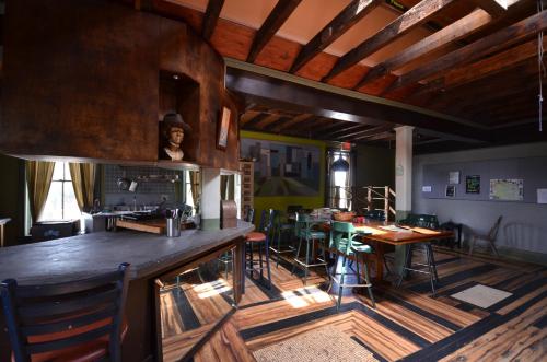 a room with a bar and a table and chairs at Michie Hostel in Providence