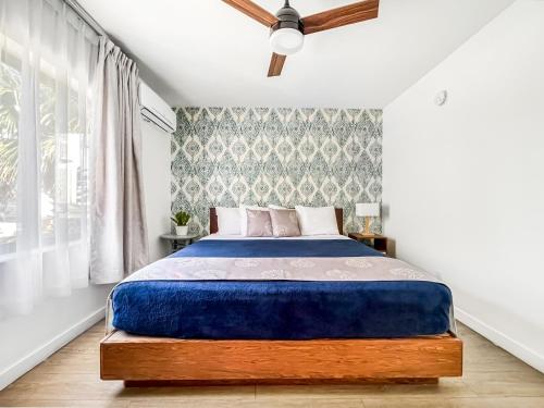 a bedroom with a bed and a ceiling fan at Ocean Sound's Hotel in Hollywood