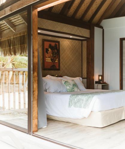 a bedroom with a large white bed in a room at Maitai Bora Bora in Bora Bora