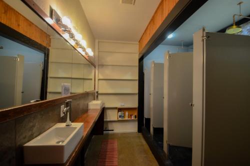 a bathroom with a sink and a mirror at Michie Hostel in Providence