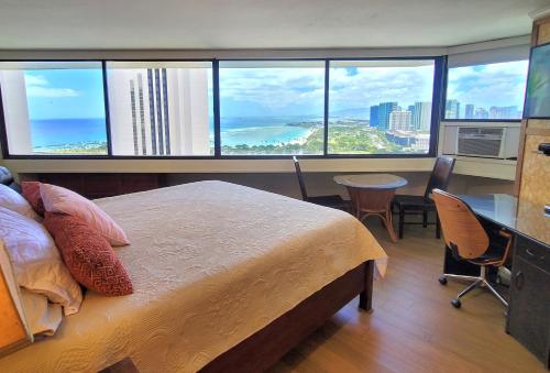 a bedroom with a bed and a view of the ocean at Spacious Studio w/ Parking, beach/mall/park in Honolulu