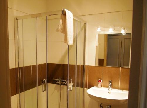 a bathroom with a shower and a sink at Hotel Areias Claras in Viana do Castelo