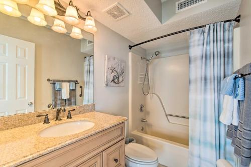 een badkamer met een wastafel, een toilet en een douche bij Relaxing Resort Retreat with Impeccable Ocean Views! in North Topsail Beach