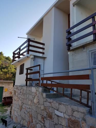 a cat is standing in front of a building at Apartments by the sea Cove Koromasna, Zirje - 15166 in Žirje
