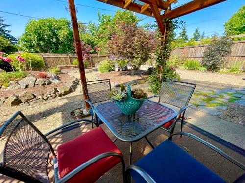 a patio table with chairs and a vase on it at Colorful 50's Ranch in the Heart of Eugene in Eugene