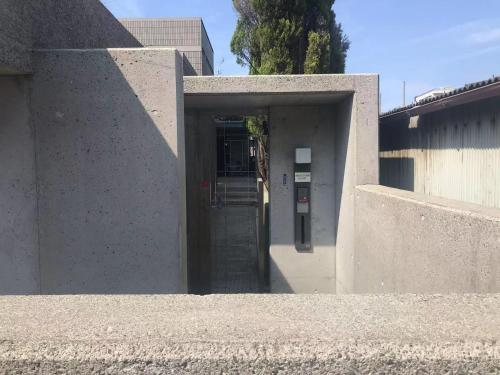 a door to a building with a parking meter at BRUCE Luxury House in Izumi-Sano