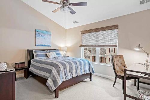 a bedroom with a bed and a ceiling fan at Comfortable Townhouse - Short Stroll to Notre Dame in South Bend