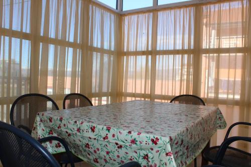 a dining room with a table and chairs and windows at Apartments and rooms with parking space Trilj, Zagora - 14609 in Trilj