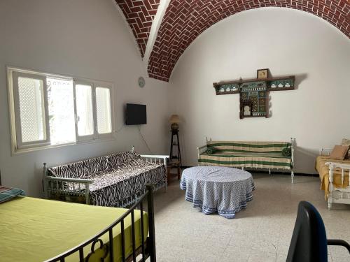 a room with two beds and a cross on the wall at Villa De la mer in Rafrāf