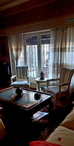 a living room with a couch and a table and chairs at Quinta Ugarte in Ciudad Lujan de Cuyo