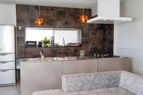 a kitchen with a sink and a refrigerator at Transit House 5S Terminal in Chatan