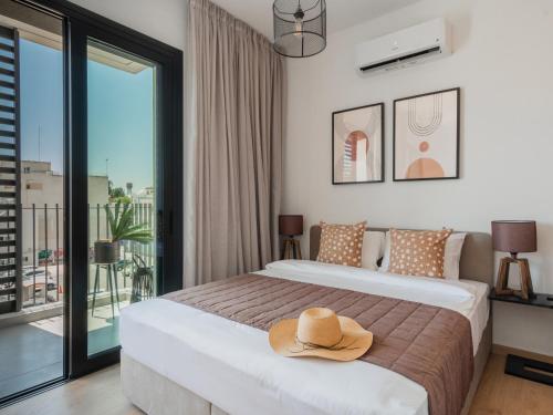 a hotel room with a bed with a hat on it at Armonta Residences by BeCyprus in Limassol