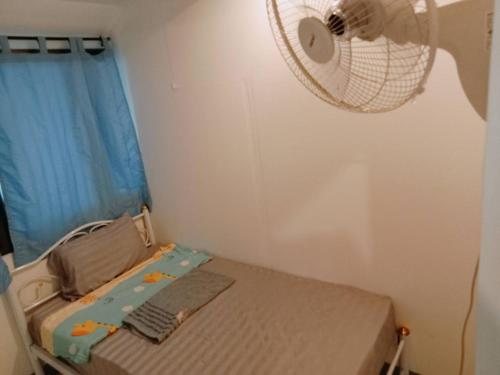 a small bedroom with a fan and a bed at 5บีบี 5BB guest house in Bangkok