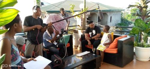 a group of people sitting in a living room at Residence Seka in Mbalngong