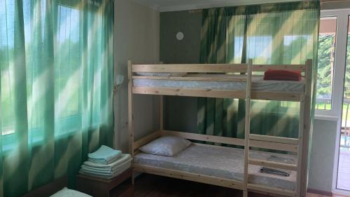 two bunk beds in a room with a window at Guest house Greenwood in Pizunda