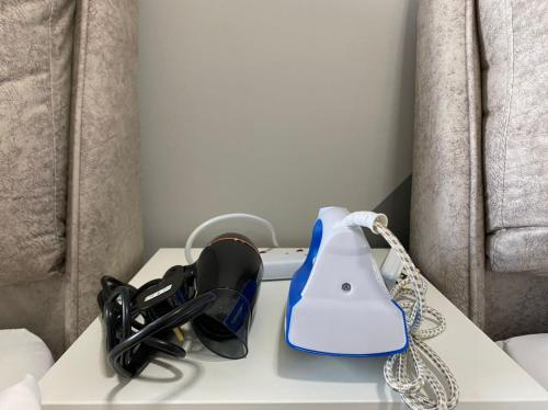 a table with a light and a telephone on it at Lucky Continew Residence 1 Bedroom - TRX KL in Kuala Lumpur