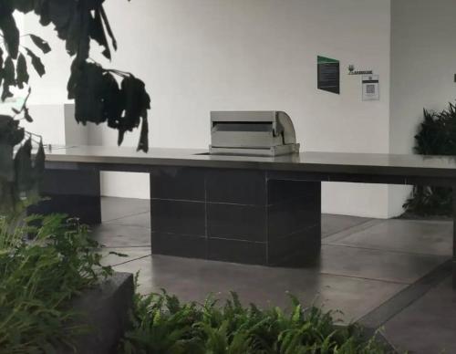 a printer sitting on a desk in a building at Lucky Continew Residence 1 Bedroom - TRX KL in Kuala Lumpur