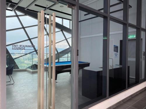 a room with a table in a building with windows at Lucky Continew Residence 1 Bedroom - TRX KL in Kuala Lumpur