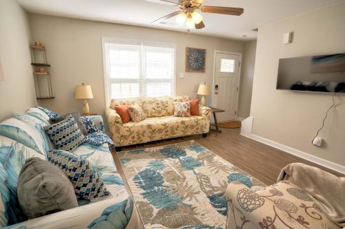 a living room with two couches and a ceiling fan at Kannapolis Elegant Townhouse - Pet Friendly in Kannapolis