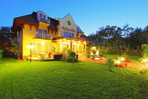 a large house with a lawn in front of it at Balazs Villa in Balatonfüred
