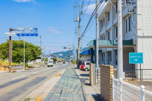 an empty city street with a building and street signs at SETOUCHI SUP RESORT - Ao - in Shodoshima