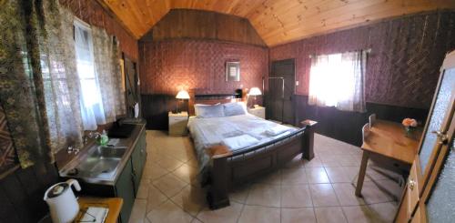 a bedroom with a bed and a sink in a room at Talbot - Rustic style accommodation with Mod Cons in Hoddy Well