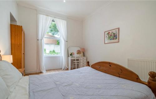 a bedroom with a large bed and a window at Newhall in Glasgow