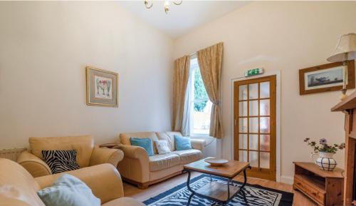 a living room with a couch and a table at Newhall in Glasgow