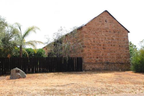 a brick building with a fence in front of it at Talbot - Historic accommodation with Mod Cons in Hoddy Well