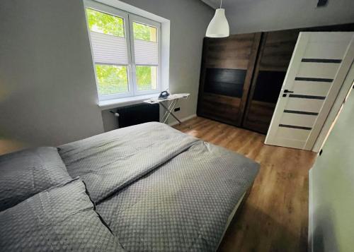 Кровать или кровати в номере Apartament Majka