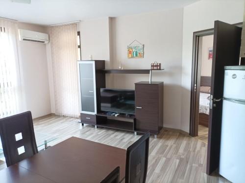 a living room with a television and a dining table at One Bedroom Apartment 10 - Vasil Aprilov 64 Plovdiv in Plovdiv