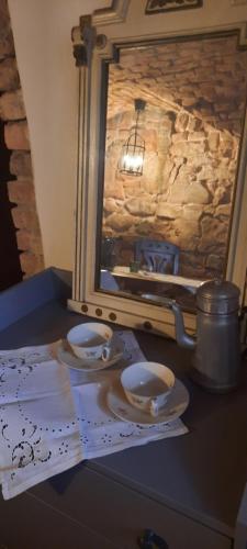 a table with plates and a mirror on a table at Penzion-apartmán U Johana in Moravská Třebová