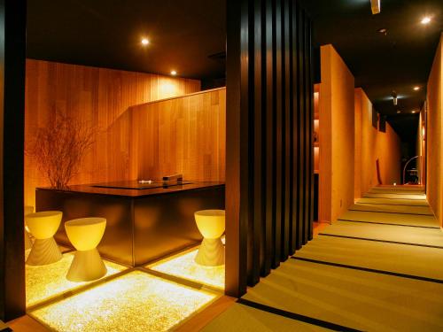 a lobby with a staircase with yellow lighting at Seikansou in Hakone