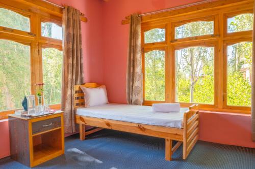 a room with a bed and a window at Maney Homestay - Thiksey - Leh in Ranbirpura