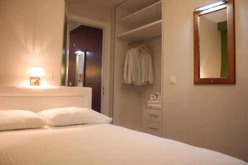 a bedroom with a bed and a mirror and a closet at TownHouse Istanbul in Istanbul