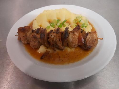 a plate of food with meat and potatoes on a table at Pension Jana - Wellness in Jilemnice