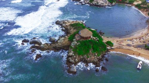 an aerial view of a small island in the ocean at Cabañas Tequendama - Parque Tayrona in El Zaino