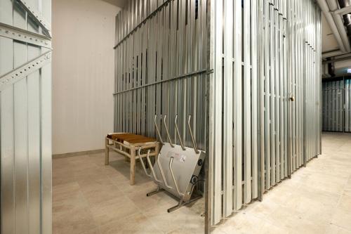 a room with a bench and a table in a building at die Tauplitz Lodges - Wasserfall Lodge C4 by AA Holiday Homes in Tauplitz
