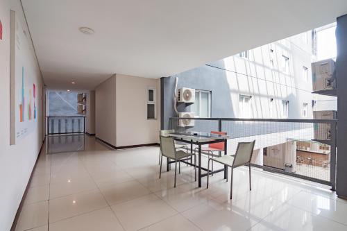 a balcony with a table and chairs in a building at RedDoorz Plus @ Dago Pojok 3 in Bandung