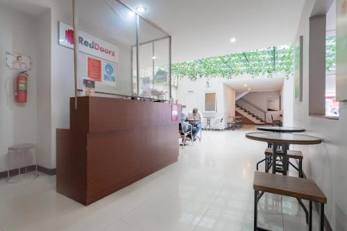 a restaurant with a counter and tables in a room at RedDoorz Plus @ Dago Pojok 3 in Bandung