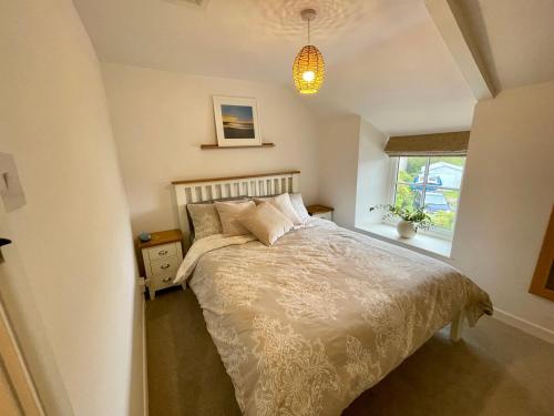 a bedroom with a bed and a window at 3 Peters Terrace in Truro