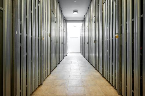 a hallway of a prison cell with a tile floor at die Tauplitz Lodges - Alm Lodge A6 by AA Holiday Homes in Tauplitz
