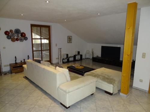 a living room with two couches and a tv at Ferienwohnung Waldweg in Grafenwiesen