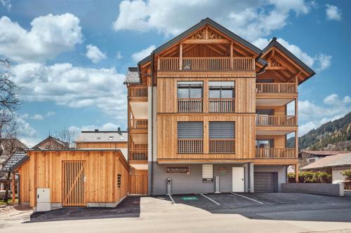 a large wooden building with a balcony at Adler Lodge D1 by AA Holiday Homes in Tauplitz