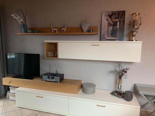 a living room with a television on a dresser at Ferienwohnung in Lechbruck am See im schönen Allgäu, nahe Füssen nur 300 m vom See in Lechbruck