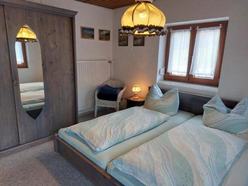 a bedroom with two twin beds and a mirror at Gerlindes Haus - inkl. Chiemgau-Karte in Siegsdorf
